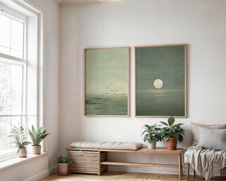 Minimalist Scandinavian wall art set of 2 showing a quiet ocean horizon in muted green tones and a glowing moon rising above the water