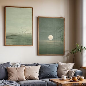 Abstract coastal artwork set of 2 featuring a flock of birds over a tranquil sea and a subtle moon reflection, in soft muted green hues