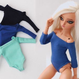 May include: Three long-sleeved leotards in navy blue, royal blue, and mint green. The leotards are made of a soft, stretchy fabric and have a fitted silhouette.