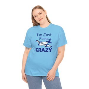 May include: A light blue t-shirt with a cartoon airplane and the text "I'm Just Plane Crazy".