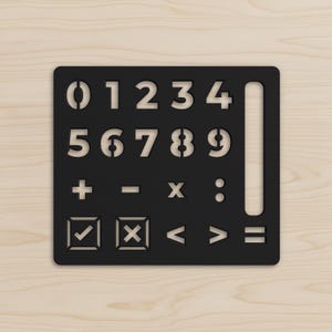 May include: A black rectangular stencil featuring cutouts of the numbers zero through nine, a long vertical slot, mathematical symbols including plus, minus, multiplication, division, checkmark, x-mark, less than, greater than, and equals signs.