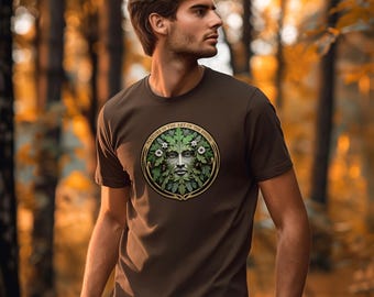 May include: A brown t-shirt featuring a circular graphic of a face made of leaves and flowers, with the text "NATURE IS THE ART OF THE DIVINE" around the edge. The shirt is short-sleeved and has a crew neck.