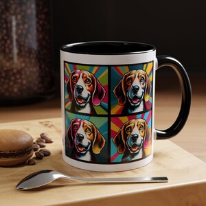 May include: A white ceramic mug with a black rim and handle. The mug features a colourful pop art design of four beagle dogs with rainbow backgrounds.