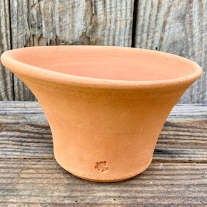 May include: A set of three ceramic mugs with a speckled, matte finish. Each mug features a different color: light blue, cream, and gray. The mugs have a simple, modern design and a comfortable handle.
