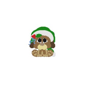 May include: A brown and white puppy wearing a green and white Santa hat with a red and green holly sprig. The puppy has big, sad eyes and is looking down.