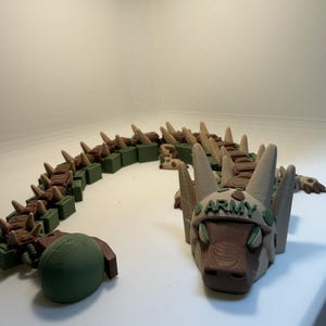 May include: A distressed wooden sign, inscribed with 'Welcome to our home' in white. The sign has a rustic appearance, ideal for a porch or hallway, and is designed with a simple, welcoming aesthetic.