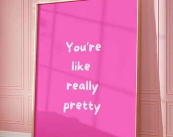 May include: A pink framed poster with the text "You're like really pretty" in white lettering.