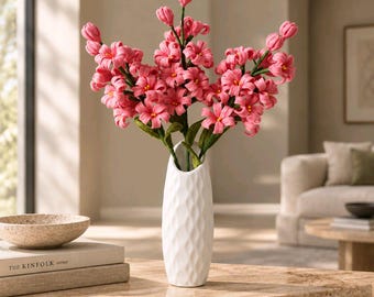 May include: A tall, white, textured ceramic vase with a tapered neck holds a bouquet of vibrant pink hyacinth flowers. The flowers feature multiple small, star-shaped blossoms on green stems, creating a dense, upright floral arrangement.