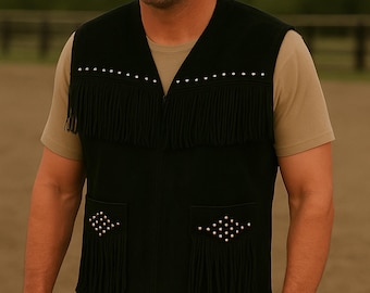 May include: A black suede vest with fringe and silver studs. The vest has two pockets with fringe and silver studs.
