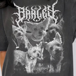 May include: Dark grey t-shirt with a graphic of five dogs and the word "BANGERS" in a stylized font. The dogs are in black and white. The shirt has a vintage, worn appearance. The t-shirt is a short-sleeved style.