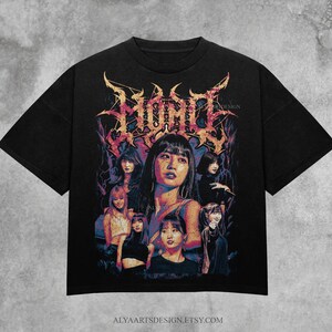 May include: Black t-shirt featuring a graphic design with the word "MOMO" in a stylized font. The design includes multiple portraits of women in various poses, with a vintage, distressed aesthetic.