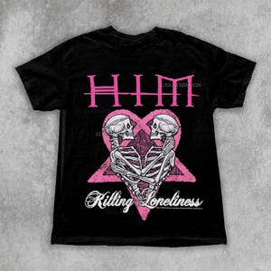 May include: Black t-shirt featuring a pink graphic with the word "HIM" above a heart-shaped design with two skeletons embracing. The text "Killing Loneliness" is below the graphic. The Etsy shop name is in the top right corner.