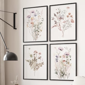 May include: Set of four watercolor prints featuring delicate floral bouquets in shades of pink, purple, and green. The prints are framed in black and arranged in a grid pattern.