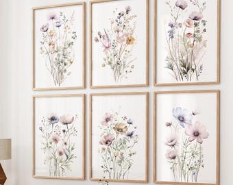 May include: Set of six framed watercolor prints featuring delicate floral bouquets in shades of pink, purple, and green. The prints are arranged in a grid pattern on a white wall.