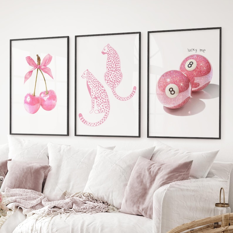 May include: Three framed art prints. The first shows pink cherries with a bow. The second depicts two pink cheetahs. The third displays two pink glittery eight balls with the text "lucky me".