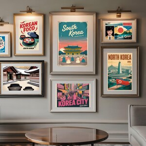 May include: A collection of framed travel posters featuring Korean themes. The posters showcase Korean food, cityscapes, and landmarks, with text such as "South Korea," "North Korea," and "Korea City." The color palette includes blues, reds, and yellows.