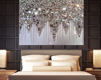 May include: A rectangular wall art piece featuring a dense arrangement of crushed silver and clear glass fragments at the top, transitioning into downward-dripping vertical lines of silver glitter against a textured white background.