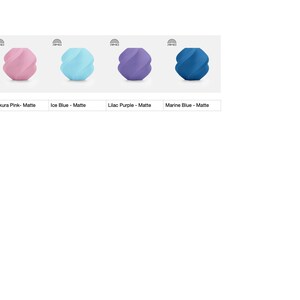 May include: Four matte finish decorative vases in a row. The vases are in shades of pink, blue, purple, and dark blue. The text below each vase indicates the color: Sakura Pink, Ice Blue, Lilac Purple, and Marine Blue.