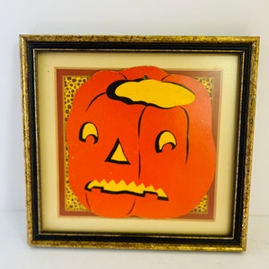 Vintage paper pumpkin cutout in frame
