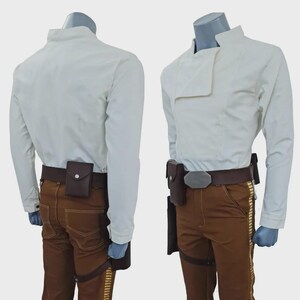 May include: A costume set featuring a long-sleeved white shirt with a high collar, brown trousers with gold-coloured side stripes, and a dark brown utility belt with a holster and a small pouch, displayed on two mannequins from front and back.