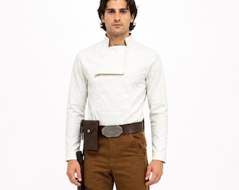May include: A long-sleeved off-white shirt with a high collar, brown trousers featuring a side stripe, a dark brown leather belt with a metallic buckle, a small attached pouch, and black knee-high boots. The outfit is worn as a complete set.