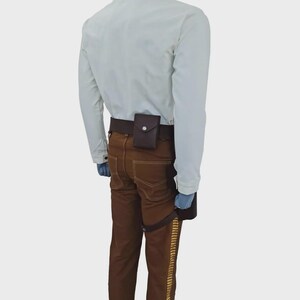 May include: A long-sleeved white shirt paired with brown trousers featuring a gold-colored side stripe. A dark brown utility belt is worn around the waist, equipped with a small rectangular pouch and a drop-leg holster attachment on the side.