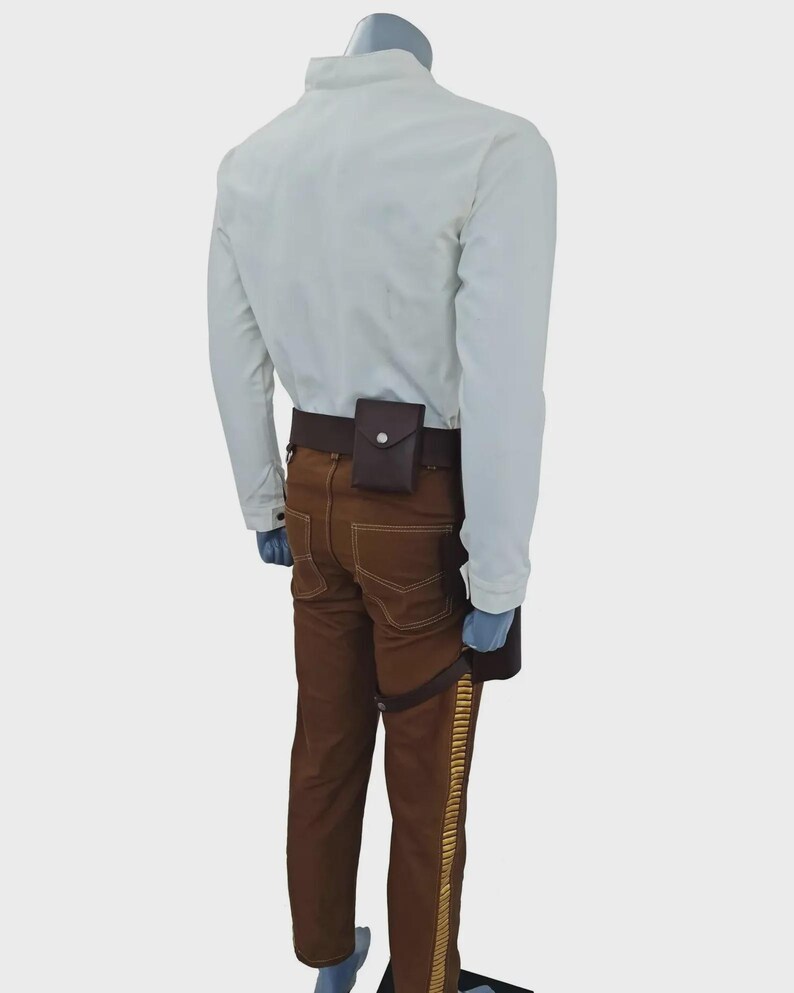 May include: A long-sleeved white shirt paired with brown trousers featuring a gold-colored side stripe. A dark brown utility belt is worn around the waist, equipped with a small rectangular pouch and a drop-leg holster attachment on the side.