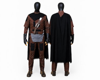 May include: A brown and black costume set displayed on two mannequins, showing front and back views. The outfit includes a brown textured shirt and pants, a black cape, black gloves, a brown utility belt with a gray pouch, and a bandolier accessory.