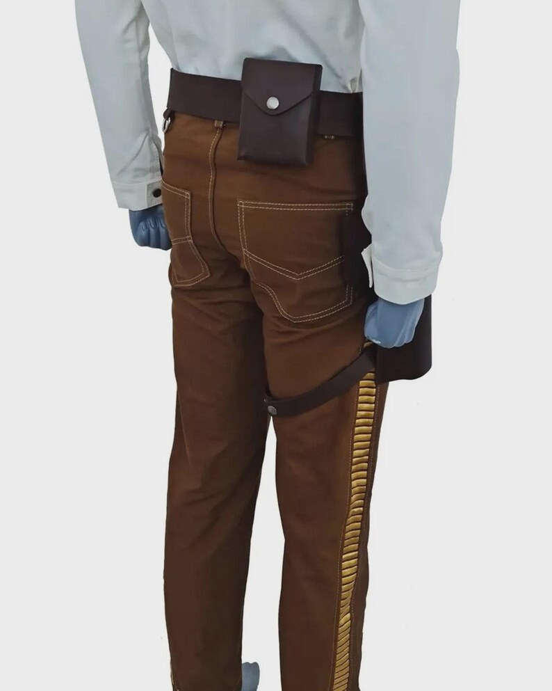 May include: Brown trousers featuring a gold-colored vertical side stripe, paired with a dark brown utility belt. The belt includes a small rectangular pouch with a snap closure and a secondary strap that secures around the upper thigh area.