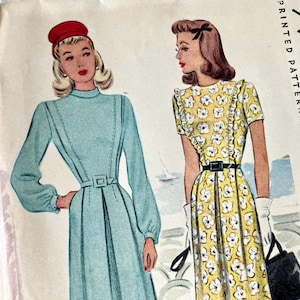 May include: Vintage McCall's printed pattern featuring illustrations of two dresses. One dress is light blue with long sleeves and a belt. The other is yellow with white floral print, short sleeves, and a black belt. The McCall's logo is visible.