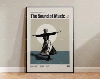 Op de afbeelding: Een ingelijste poster voor de film "The Sound of Music". Het minimalistische ontwerp toont een vrouw in een jurk met uitgestrekte armen tegen een neutrale achtergrond. De poster heeft een zwarte lijst en toont het jaar 1965.