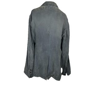 May include: A charcoal gray blazer featuring a collared neckline, long sleeves with four black buttons at each cuff, and a single back vent. The garment has a subtle, weathered texture throughout and a small circular logo detail at the nape.