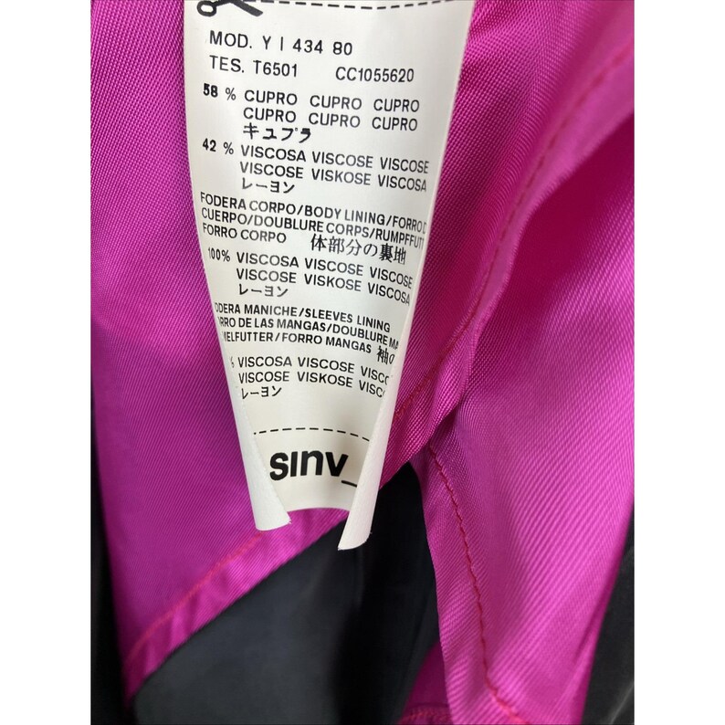 May include: A white garment care label with black text attached to a bright pink lining. The label lists the model number Y 434 80, material composition of 58% cupro and 42% viscose, and lining details. The brand name sinv is printed at the bottom.