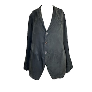 May include: A charcoal gray blazer featuring a notched lapel, long sleeves, and a three-button front closure. The garment has a soft, slightly wrinkled texture and includes two large patch pockets on the lower front section of the jacket.