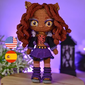 May include: Crocheted doll of a character with brown skin, curly red hair, and large yellow eyes. The doll wears a black jacket, purple skirt, and purple boots. The doll has a tiger-striped top and gold accents. The doll is handmade.