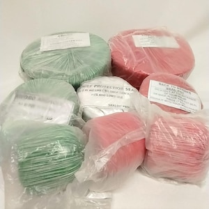 May include: Assortment of green and red twine rolls, some with labels. The twine is packaged in clear plastic. The labels contain text, including "Chief Protection Seal" and "Back to Bender Seal Pot".