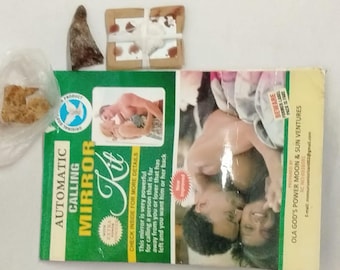 May include: An assortment of items including an "Automatic Calling Mirror Kit" box with text and an image of a couple. Also present are small, wrapped packages and a small, cone-shaped object. The box has green and white text.