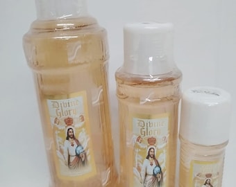May include: Three clear glass bottles with gold labels featuring an image of Jesus Christ. The labels read "Divine Glory".