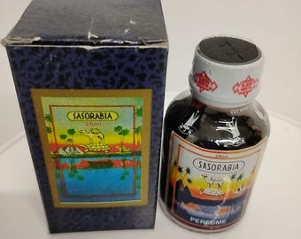 May include: A perfume bottle and its box. The bottle is dark with a white label that reads "SASORABIA" and "PERFUME". The box is dark blue with a gold label that reads "SASORABIA" and depicts a landscape scene.