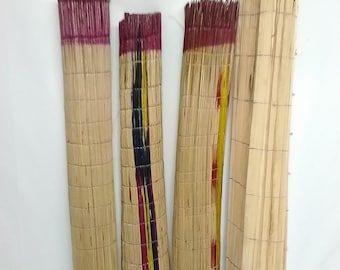 May include: Four rectangular woven mats. Three mats have a natural tan color with a dark red border. One mat has a black and yellow stripe design. The fourth mat is made of light brown wooden slats.