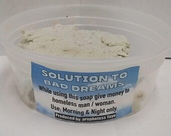 May include: A clear plastic container filled with a light-colored, textured substance. A blue label with white text reads "SOLUTION TO BAD DREAMS." Additional text on the label provides usage instructions. The product is labeled as being produced by "prophetess Tayo."