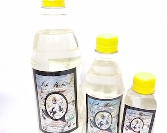 May include: Three clear bottles of cologne with yellow caps. Each bottle has a label with the text "Jah Michael Eau de Cologne" and a graphic of a horse. The bottles vary in size, with the largest bottle on the left and the smallest on the right.
