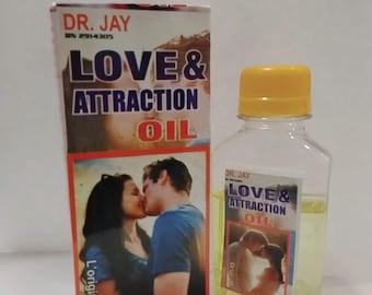 May include: A clear plastic bottle with a yellow cap and a box labeled "DR. JAY LOVE & ATTRACTION OIL." The box and bottle feature images of a kissing couple. The oil inside the bottle is yellow.