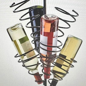 May include: A black metal wine rack holding four wine bottles. The rack has a spiral design and a wooden base. The bottles are filled with red, white, and rosé wine. The rack is designed to hold the bottles at an angle.