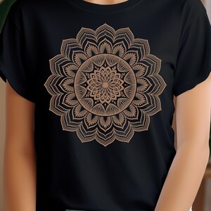 May include: A black t-shirt with a brown mandala design printed on the front.