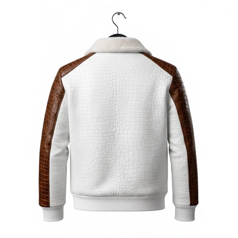 May include: White jacket with brown faux leather sleeves and accents, hanging on a black hanger. The jacket has a textured pattern on the white body and a fluffy white collar. The cuffs and hem are white.