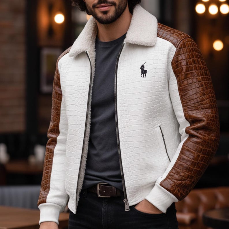 May include: White and brown jacket with a faux-crocodile texture. The jacket has brown sleeves, a white body, and a cream-colored shearling collar. A black logo is on the chest. The jacket is zipped up and has a ribbed hem and cuffs.