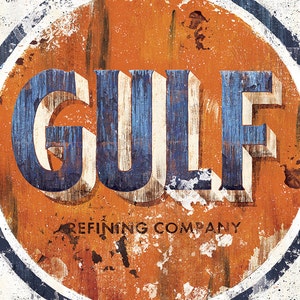 May include: Vintage-style sign featuring the word "GULF" in blue and white, set against an orange background. The sign also includes the text "REFINING COMPANY" in black, with a distressed, weathered appearance.