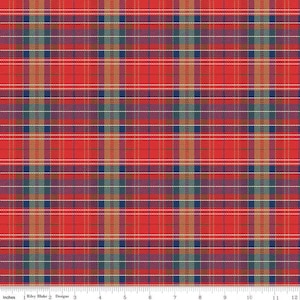 May include: Red plaid fabric with a pattern of intersecting lines in red, blue, gold, and white. The fabric has a classic tartan design, suitable for various crafting projects. The image includes a ruler showing inches.