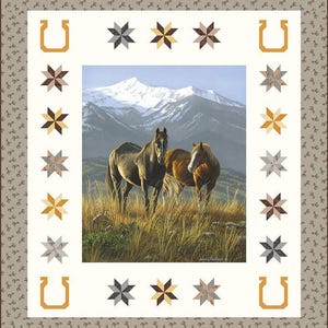 May include: A quilt featuring a central image of two horses in a field with a mountain backdrop. The quilt has a white border with star and horseshoe patterns, and a brown patterned outer border. The horses are brown and gray.